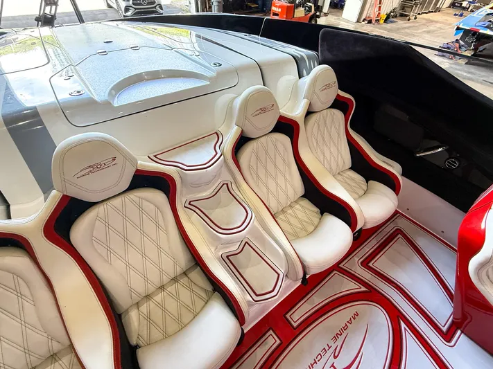  Yacht Photos Pics Luxurious interior of a 2019 MTI 48 boat with white and red seating.