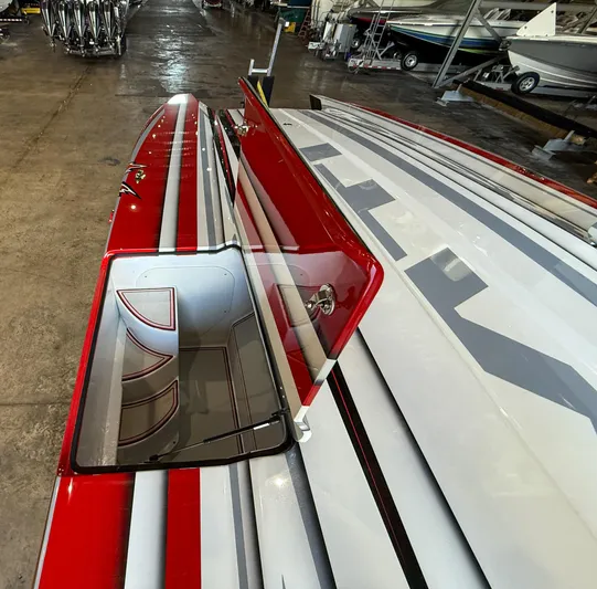  Yacht Photos Pics Red and white MTI 48 boat with open hatch, stored indoors, 2019 model.