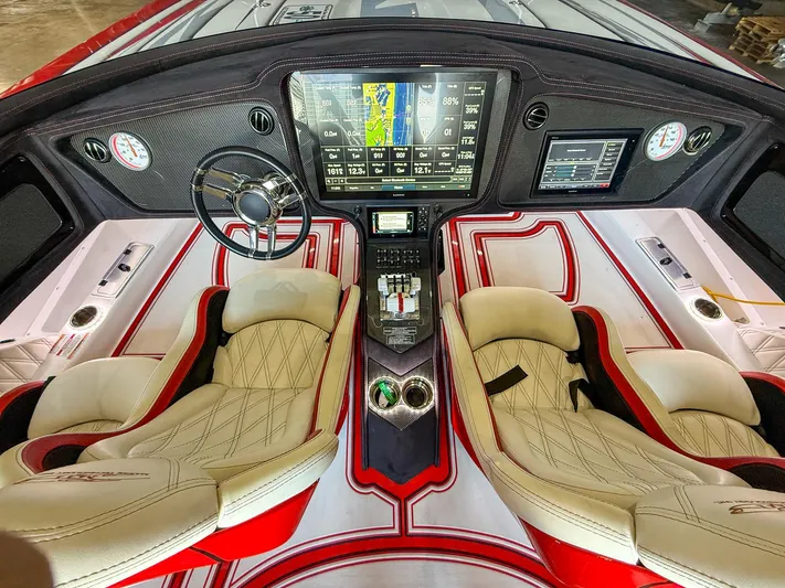  Yacht Photos Pics Luxurious 2019 MTI 48 boat interior with advanced dashboard and plush seating.