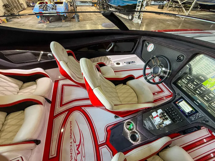  Yacht Photos Pics Luxurious 2019 MTI 48 boat interior with plush seating, advanced dashboard, and sleek design.