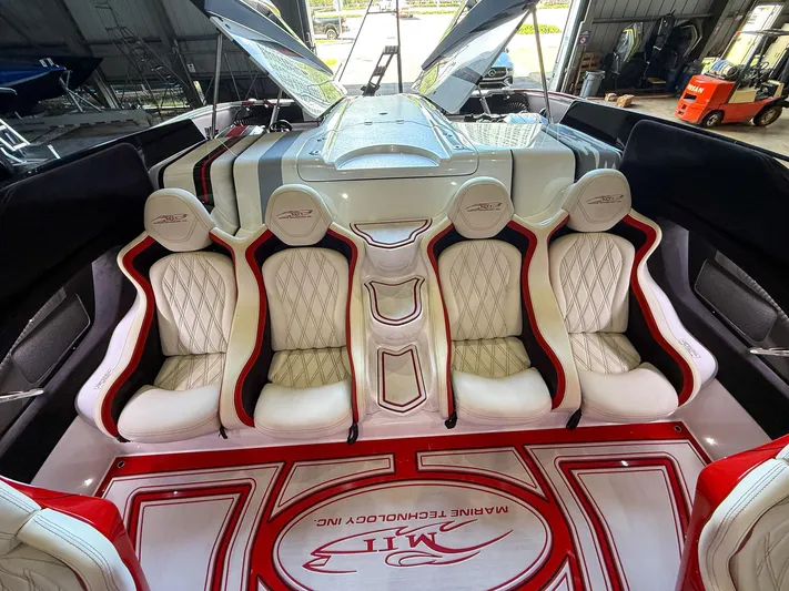  Yacht Photos Pics Luxurious interior of a 2019 MTI 48 boat with white and red seating.