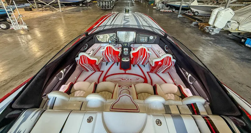  Yacht Photos Pics Interior of a 2019 MTI 48 boat with red and white seating in a warehouse.