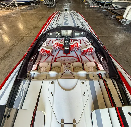  Yacht Photos Pics Interior of a 2019 MTI 48 speedboat with red and white seating.