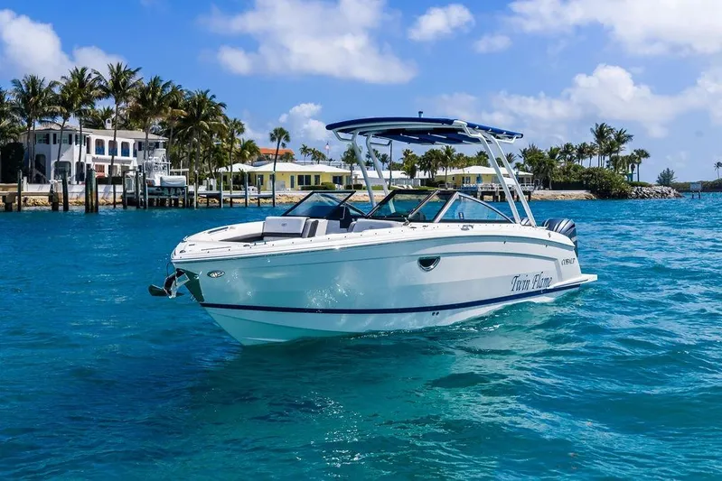 Twin Flame Yacht Photos Pics 2022 Cobalt R8 Outboard boat on clear blue water near tropical shoreline.