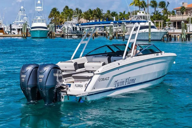 Twin Flame Yacht Photos Pics 2022 Cobalt R8 Outboard boat with twin Yamaha engines in a marina setting.