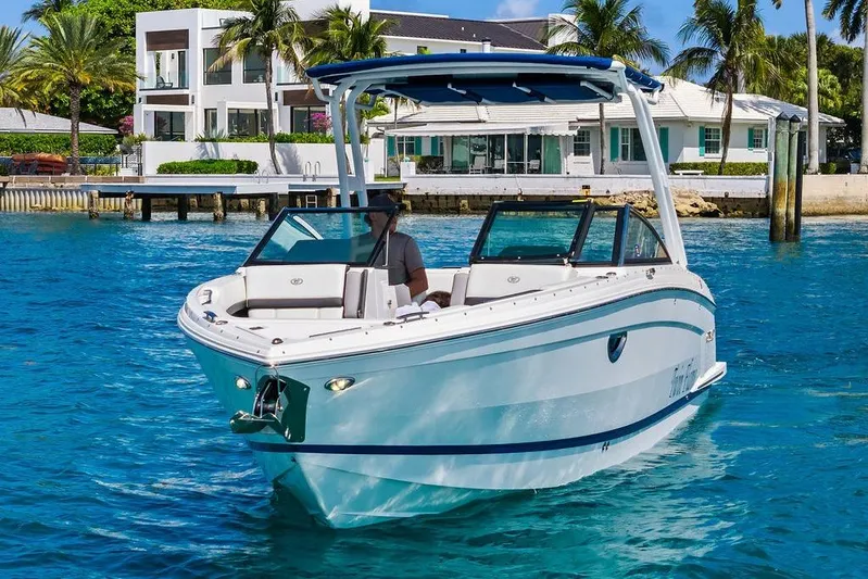 Twin Flame Yacht Photos Pics 2022 Cobalt R8 Outboard boat cruising in clear blue water near luxury waterfront homes.