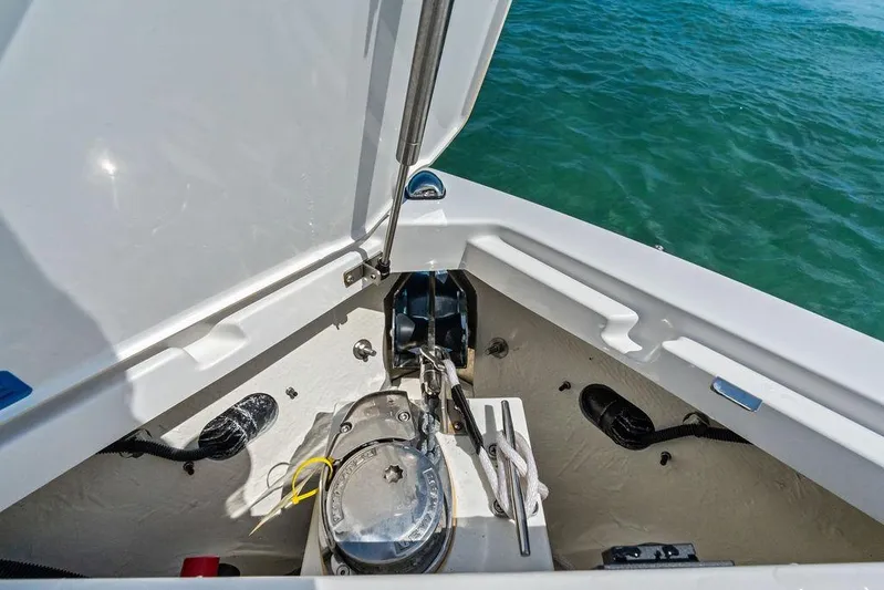 Twin Flame Yacht Photos Pics 2022 Cobalt R8 Outboard boat anchor compartment with open hatch, near water.