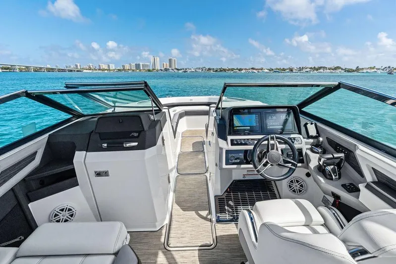Twin Flame Yacht Photos Pics 2022 Cobalt R8 Outboard boat interior with modern dashboard, steering wheel, and ocean view.
