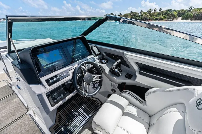 Twin Flame Yacht Photos Pics 2022 Cobalt R8 Outboard boat cockpit with modern controls and scenic ocean view.