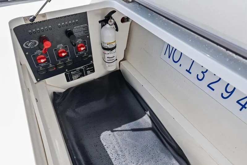 Twin Flame Yacht Photos Pics Control panel and fire extinguisher in 2022 Cobalt R8 Outboard boat compartment.