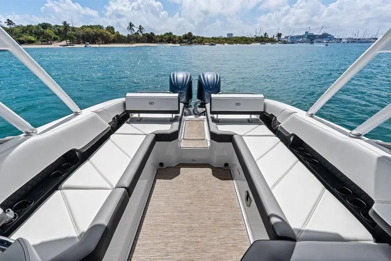 Twin Flame Yacht Photos Pics 2022 Cobalt R8 Outboard boat interior with spacious seating, overlooking serene blue waters.
