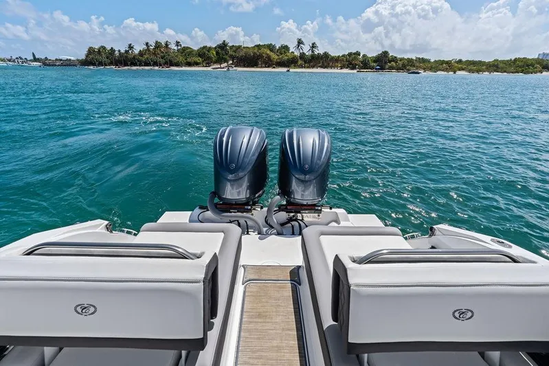 Twin Flame Yacht Photos Pics 2022 Cobalt R8 Outboard boat on water, tropical island in background.