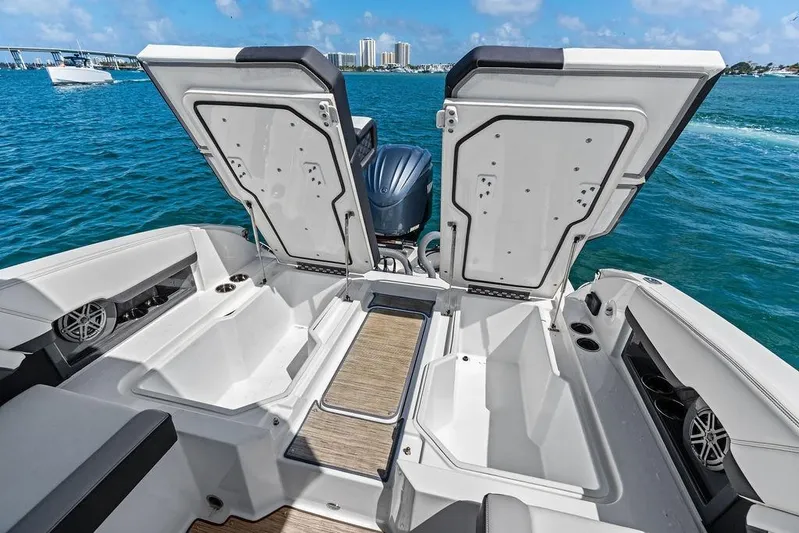 Twin Flame Yacht Photos Pics 2022 Cobalt R8 Outboard boat with open storage compartments on a sunny day.