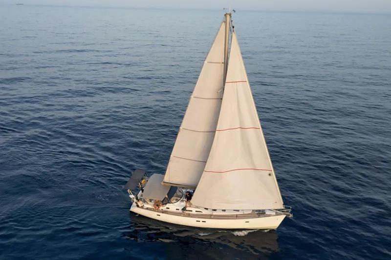  Yacht Photos Pics Sailing yacht Beneteau Oceanis Clipper 473, 2002 model, cruising on calm ocean waters.