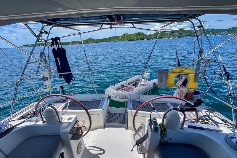  Yacht Photos Pics Cockpit view of 2002 Beneteau Oceanis Clipper 473 sailboat on tranquil water.