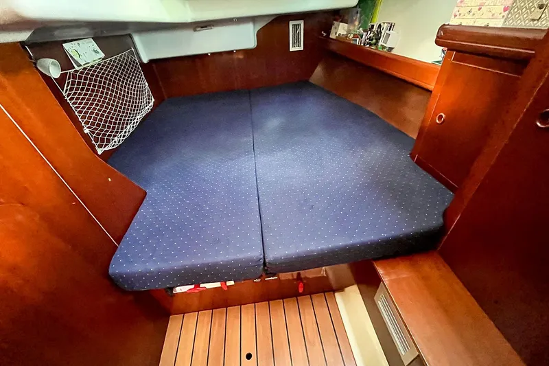  Yacht Photos Pics Cozy cabin interior of 2002 Beneteau Oceanis Clipper 473 sailboat with blue bedding.