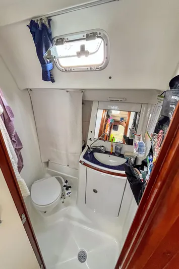  Yacht Photos Pics Bathroom interior of a 2002 Beneteau Oceanis Clipper 473 yacht, featuring a compact design.