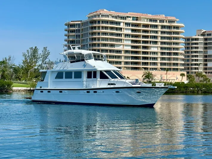 Leslie Jane Yacht Photos Pics 2002 Jefferson Marquessa 57 MY yacht cruising near waterfront buildings.