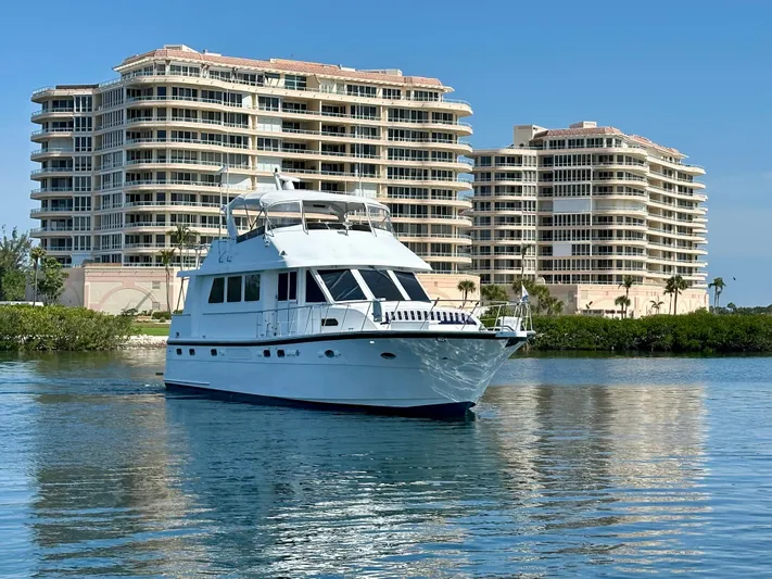 Leslie Jane Yacht Photos Pics 2002 Jefferson Marquessa 57 MY yacht cruising near luxury waterfront buildings.