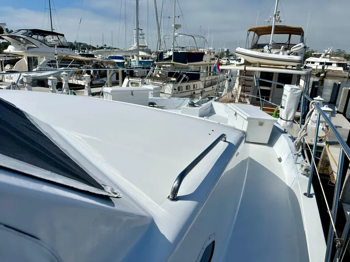 Leslie Jane Yacht Photos Pics 2002 Jefferson Marquessa 57 MY yacht docked among other boats in a marina.