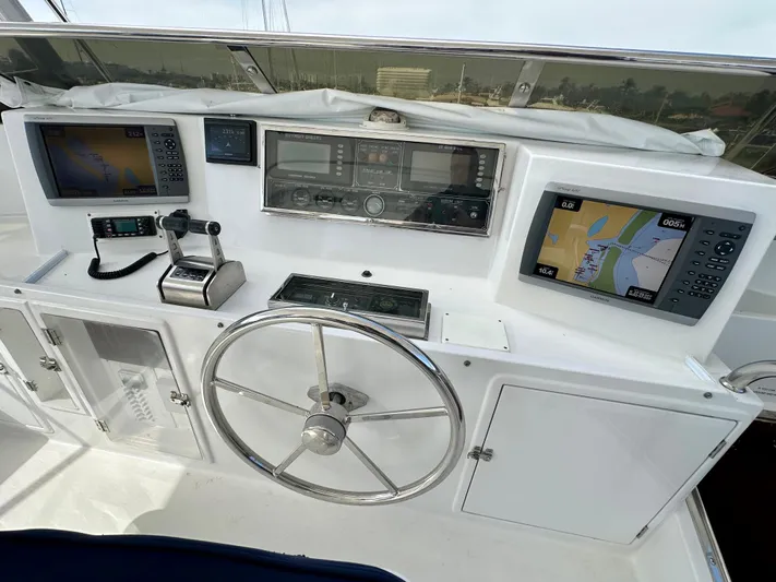 Leslie Jane Yacht Photos Pics Helm of 2002 Jefferson Marquessa 57 MY with navigation equipment and steering wheel.