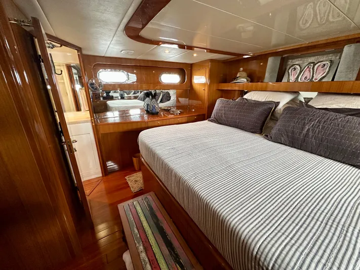 Leslie Jane Yacht Photos Pics Luxurious bedroom interior of 2002 Jefferson Marquessa 57 MY yacht with wood paneling.