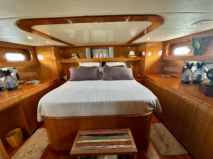 Leslie Jane Yacht Photos Pics Luxurious bedroom interior of 2002 Jefferson Marquessa 57 MY yacht with wood paneling.