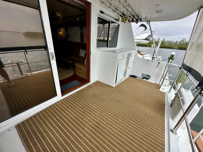 Leslie Jane Yacht Photos Pics Jefferson Marquessa 57 MY 2002 yacht deck with striped flooring and interior view.
