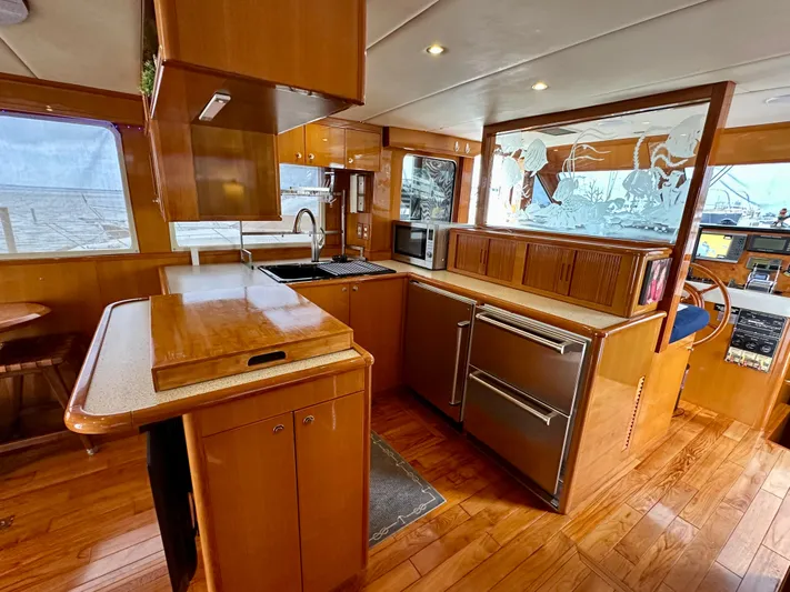 Leslie Jane Yacht Photos Pics Luxurious 2002 Jefferson Marquessa 57 MY yacht kitchen with wood cabinetry and modern appliances.