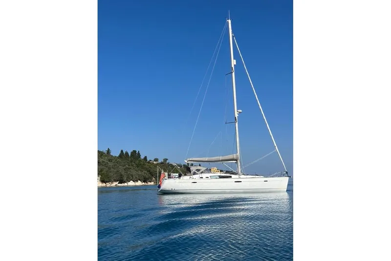  Yacht Photos Pics 2007 Beneteau Oceanis 50 sailboat on calm blue water, clear sky background.