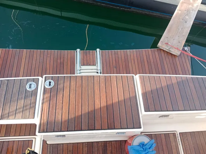  Yacht Photos Pics Dufour 412 Grand Large 2018 yacht deck with wooden finish and swim ladder.