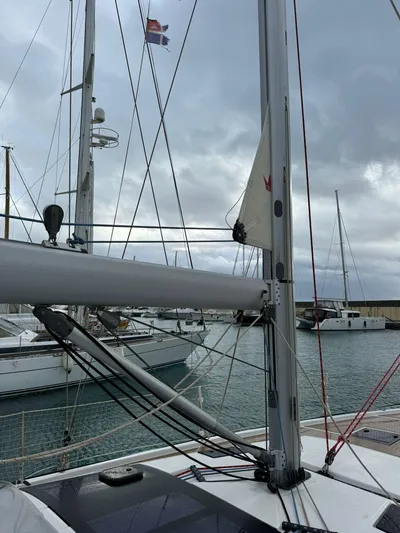  Yacht Photos Pics Dufour 470 sailboat mast and rigging in a marina, cloudy sky, 2022 model.