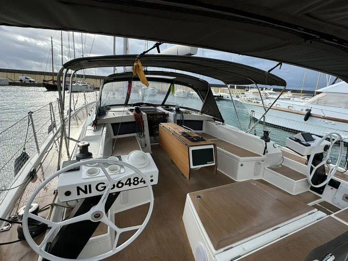  Yacht Photos Pics 2022 Dufour 470 sailboat cockpit with dual steering wheels and spacious seating area.