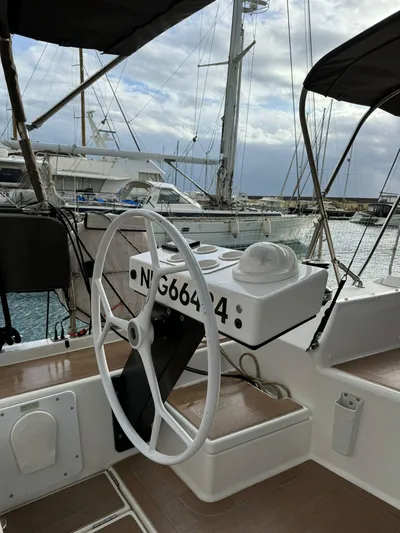  Yacht Photos Pics Steering wheel of a 2022 Dufour 470 yacht docked at a marina.