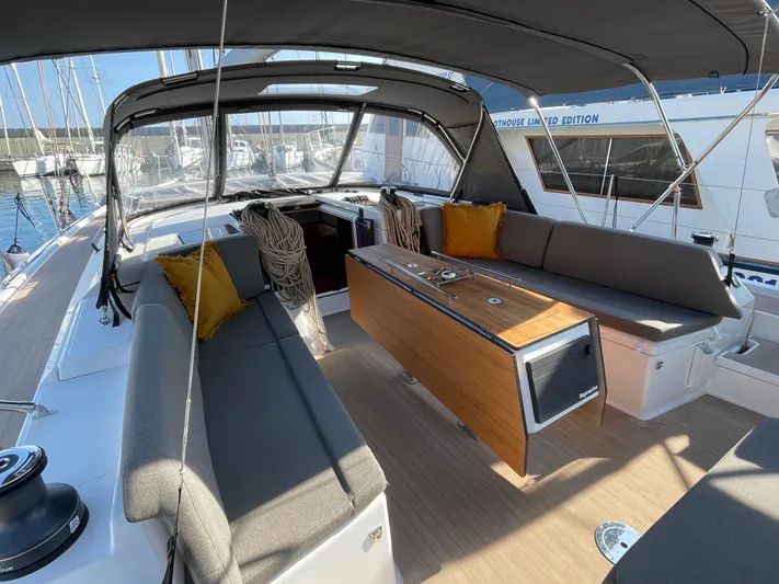  Yacht Photos Pics Spacious cockpit of 2022 Dufour 470 yacht with seating and table.
