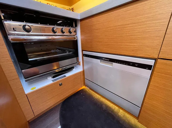  Yacht Photos Pics Modern kitchen appliances in a 2022 Dufour 470 yacht, featuring an oven and dishwasher.
