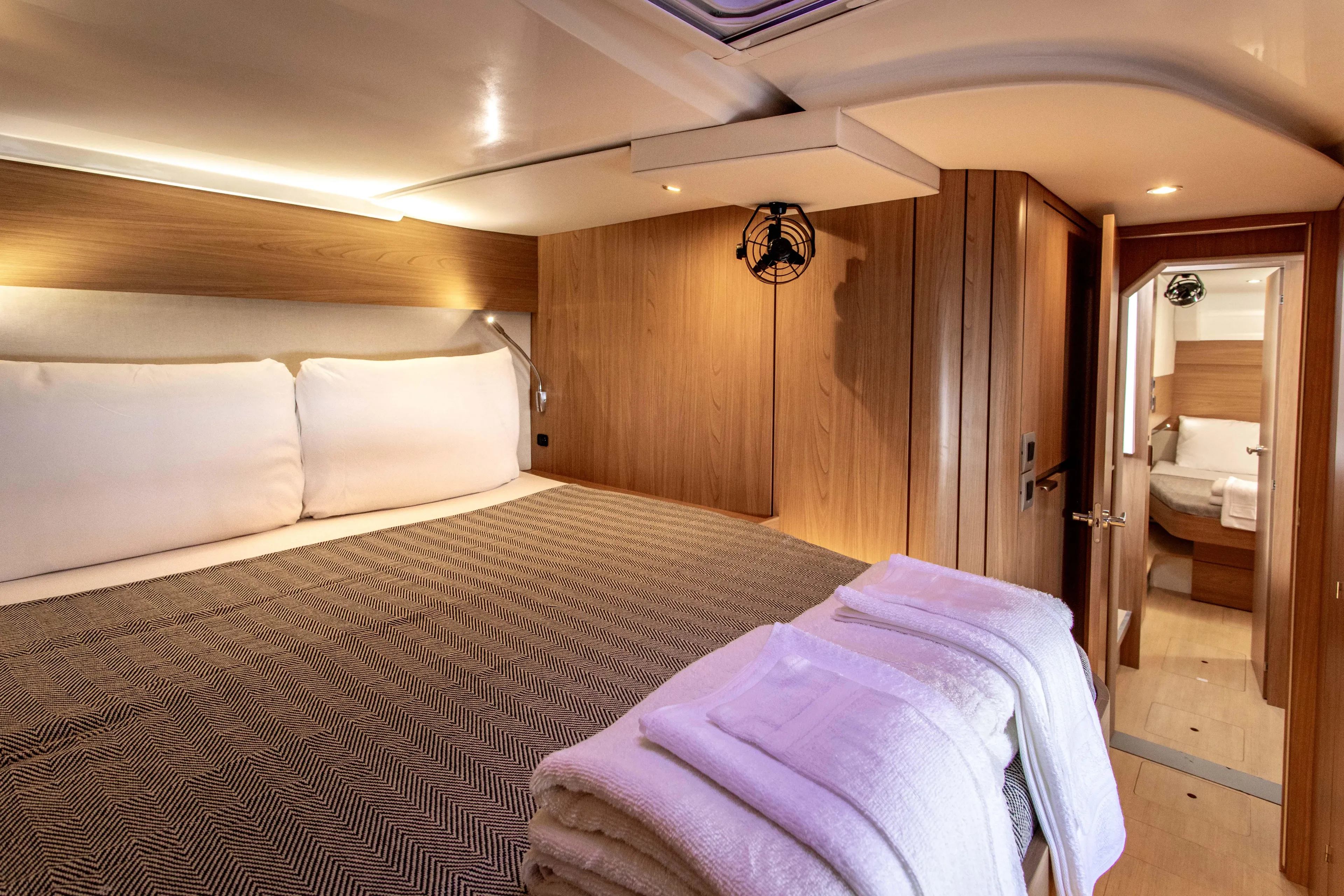 Lucky Fin Yacht Photos Pics Luxurious cabin interior of 2024 Bali CATSPACE yacht with cozy bedding and modern design.
