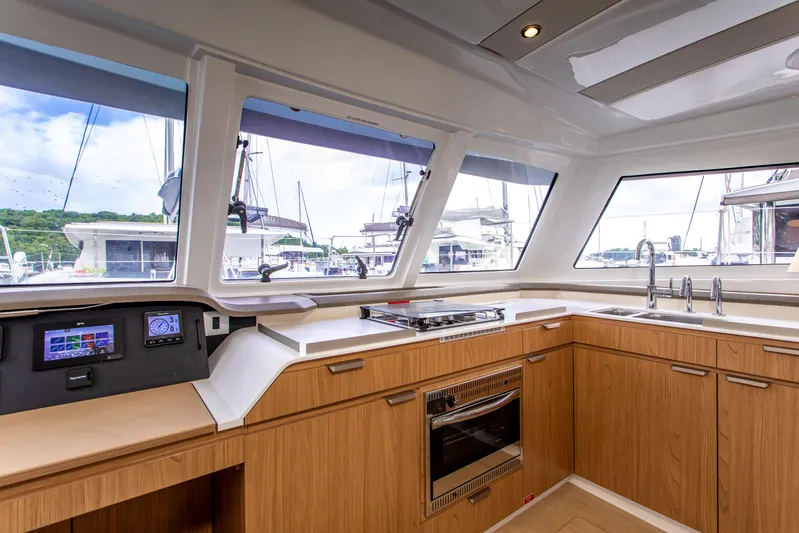 Lucky Fin Yacht Photos Pics 2024 Bali CATSPACE yacht kitchen with modern appliances and panoramic windows.