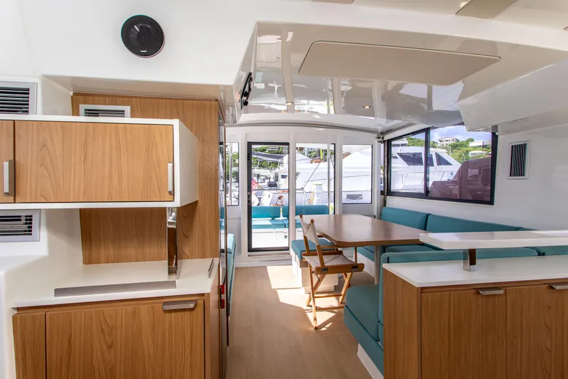 Lucky Fin Yacht Photos Pics Interior of 2024 Bali CATSPACE catamaran with modern kitchen and seating area.