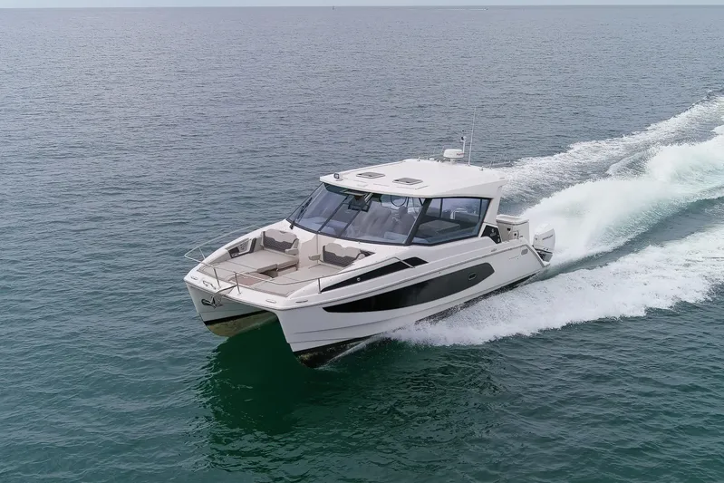  Yacht Photos Pics 2023 Aquila 36 Sport cruising on open water, showcasing sleek design and performance.