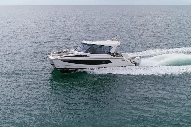  Yacht Photos Pics 2023 Aquila 36 Sport cruising on open water, showcasing sleek design and performance.