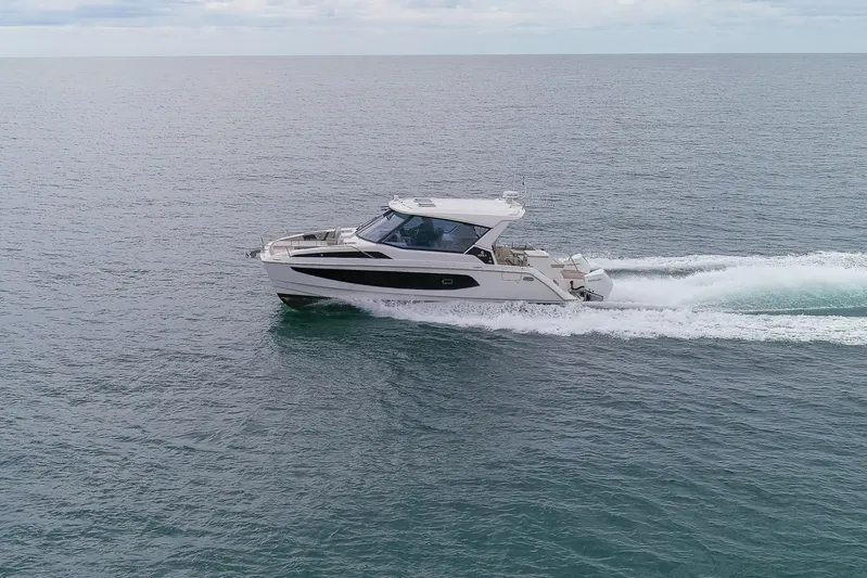  Yacht Photos Pics 2023 Aquila 36 Sport yacht cruising on open water.