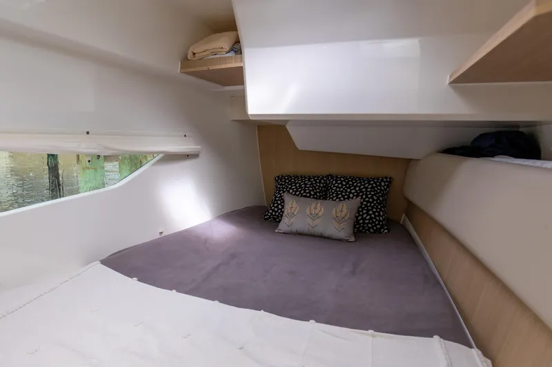  Yacht Photos Pics Cozy cabin interior of 2023 Aquila 36 Sport with plush bedding and decorative pillows.