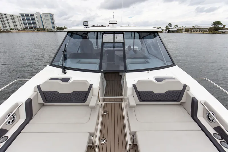  Yacht Photos Pics 2023 Aquila 36 Sport boat with spacious seating and modern design on a calm waterway.