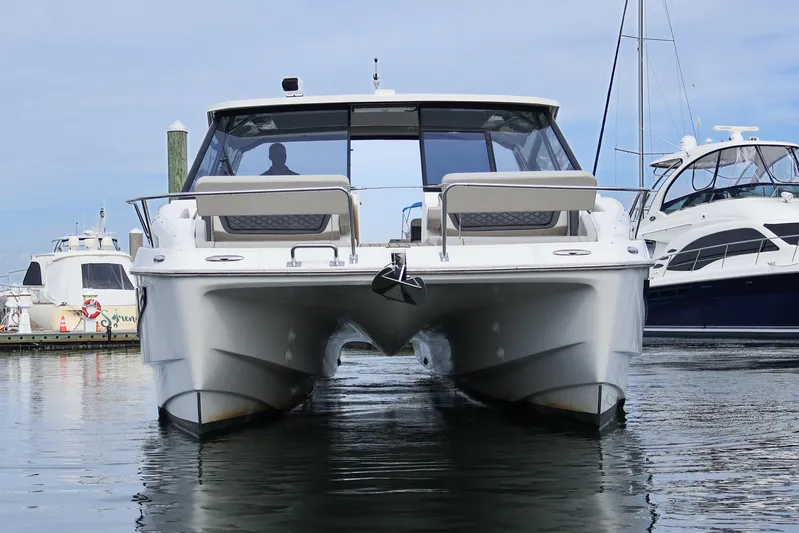  Yacht Photos Pics 2023 Aquila 36 Sport catamaran docked in marina, front view.