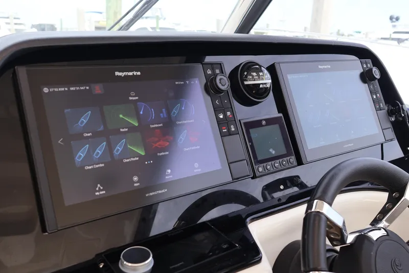  Yacht Photos Pics 2023 Aquila 36 Sport dashboard with dual Raymarine displays and navigation controls.