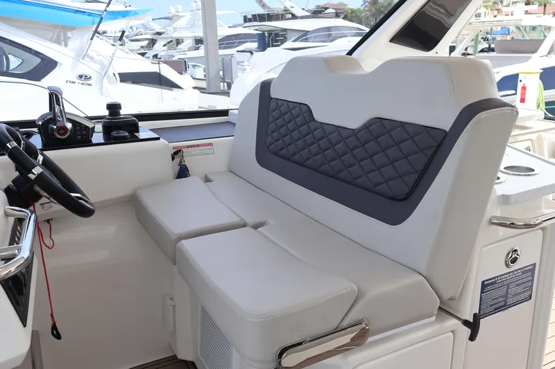  Yacht Photos Pics 2023 Aquila 36 Sport interior with modern helm and cushioned seating.