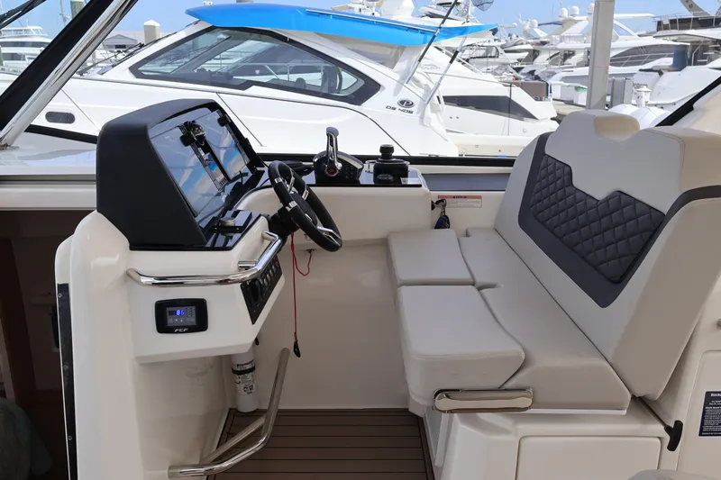  Yacht Photos Pics 2023 Aquila 36 Sport boat interior with modern helm and seating at marina.