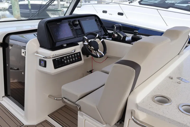  Yacht Photos Pics 2023 Aquila 36 Sport boat helm with modern controls and comfortable seating.