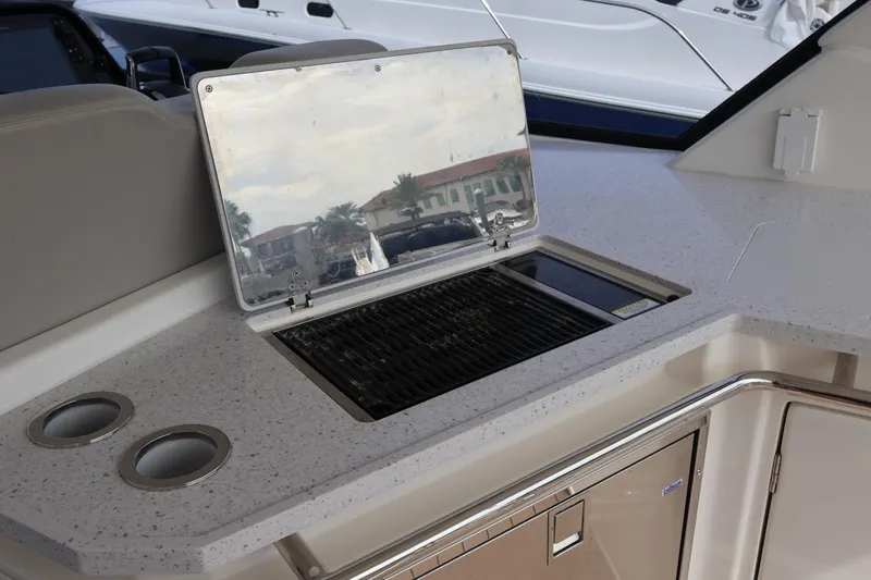  Yacht Photos Pics Outdoor kitchen on 2023 Aquila 36 Sport yacht with grill and cup holders.